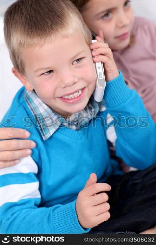 Portrait of kids talking on mobile phone
