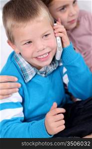Portrait of kids talking on mobile phone