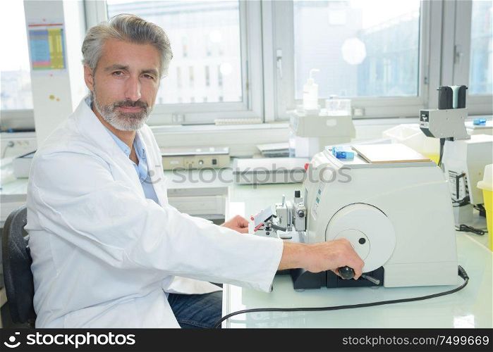 Portrait of laboratory technician operating equipment