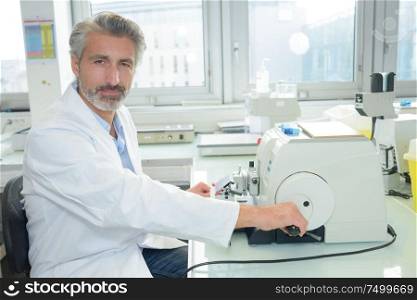 Portrait of laboratory technician operating equipment