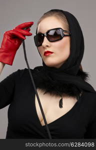 portrait of lady in black headscarf and red gloves with crop