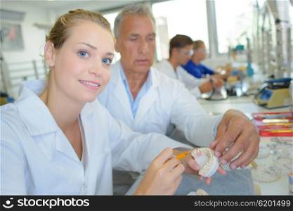 Portrait of lady working on dentures