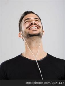Portrait of latin man smiling and listen music