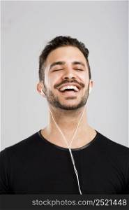 Portrait of latin man smiling and listen music