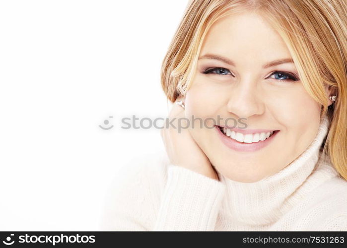 Portrait of laughing blonde in the white sweater, isolated
