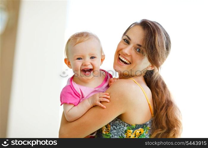 Portrait of laughing mother and baby