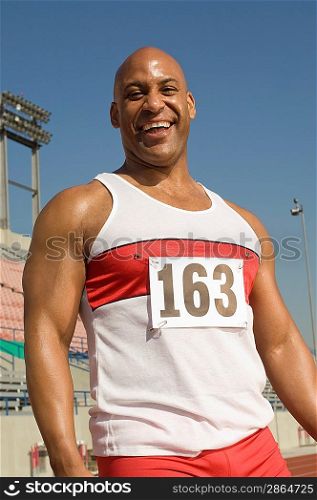 Portrait of laughing runner on a track