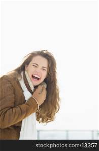Portrait of laughing young woman in winter outdoors