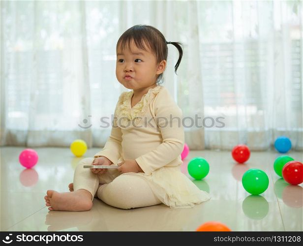 Portrait of little asian girl in home