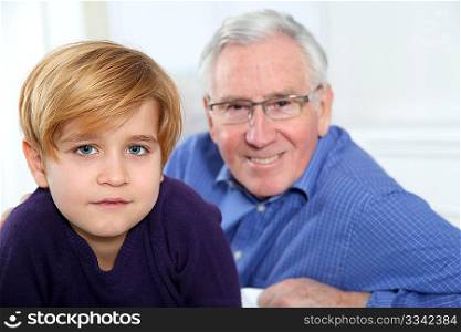 Portrait of little blond boy with grandfather