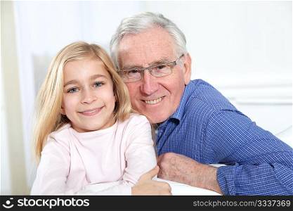 Portrait of little blond girl with grandfather