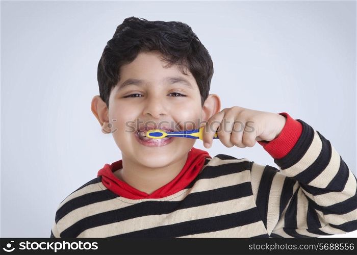 Portrait of little boy brushing his teeth