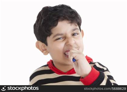Portrait of little boy brushing his teeth