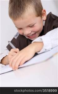 Portrait of little boy doing his homework
