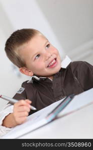 Portrait of little boy doing homework