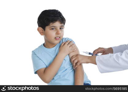 Portrait of little boy getting an injection