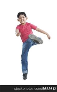 Portrait of little boy jumping in the air