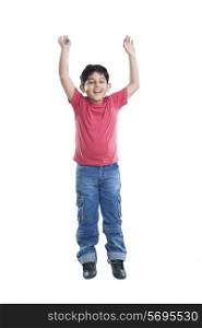 Portrait of little boy jumping in the air