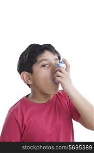 Portrait of little boy using an inhaler
