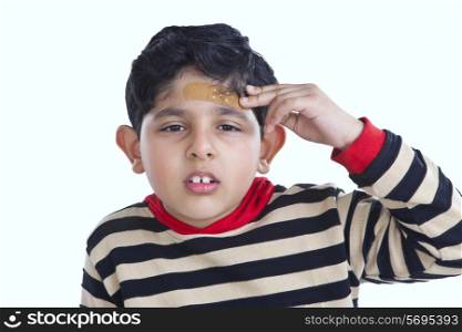 Portrait of little boy with band-aid on forehead