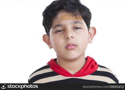 Portrait of little boy with band-aid on forehead