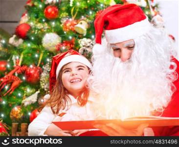 Portrait of little charming baby girl with Santa Claus reading magical Christmas story, enjoying wonderful festive fairy tale