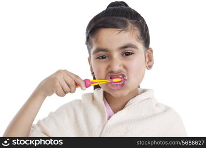 Portrait of little girl brushing her teeth