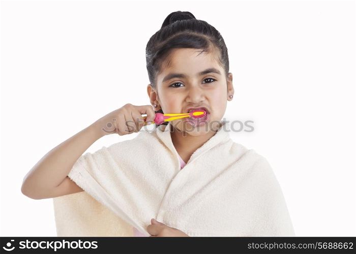 Portrait of little girl brushing her teeth