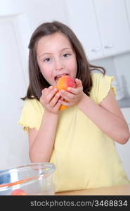 Portrait of little girl eating apricots