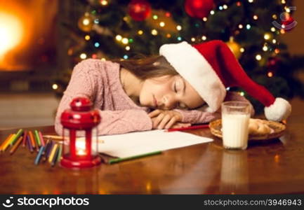 Portrait of little girl felt asleep while writing to Santa