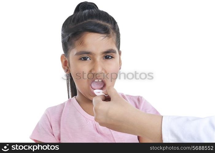 Portrait of little girl having medicine