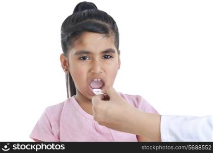 Portrait of little girl having medicine