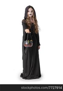 Portrait of little girl in black cloak clothing with cauldron basket of worm sweets isolated on white background, Halloween witch costume, party time, going trick or treating.. Halloween witch girl with cauldron of sweets