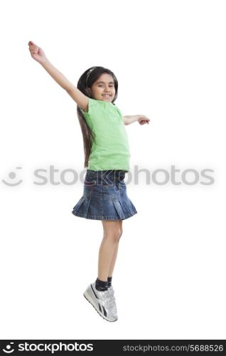 Portrait of little girl jumping in the air