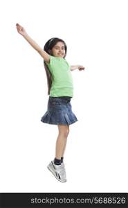 Portrait of little girl jumping in the air
