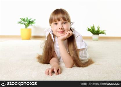 portrait of little girl on the floor in studio