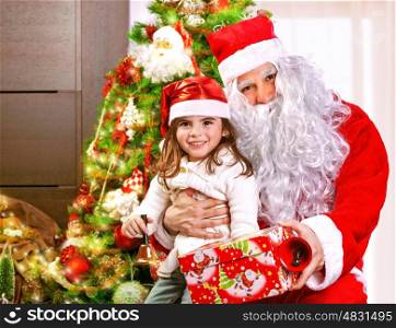 Portrait of little girl receive gift box from Santa Claus, sitting near decorated Christmas tree, happy childhood, Christmastime children's party