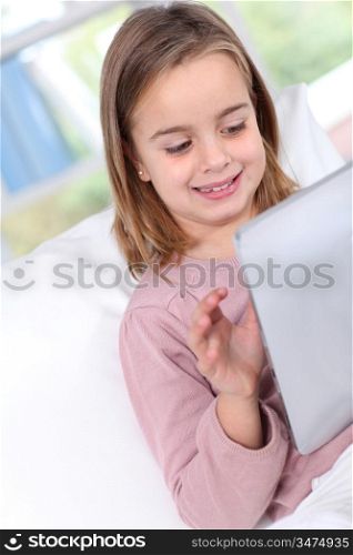 Portrait of little girl using electronic tablet