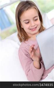 Portrait of little girl using electronic tablet