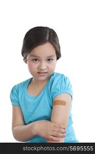 Portrait of little girl with band-aid on arm