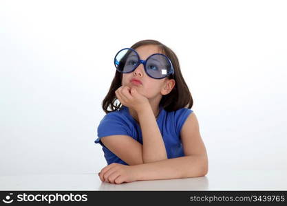 Portrait of little girl with funny sunglasses on