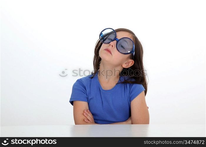 Portrait of little girl with funny sunglasses on
