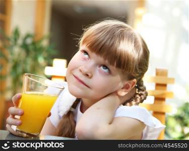 portrait of little girl with orange juice outdoors