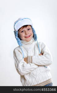 Portrait of little kid in winter wear against white background