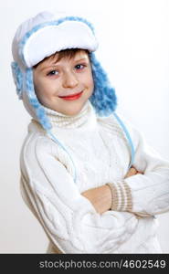 Portrait of little kid in winter wear against white background