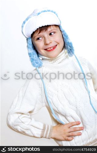 Portrait of little kid in winter wear against white background