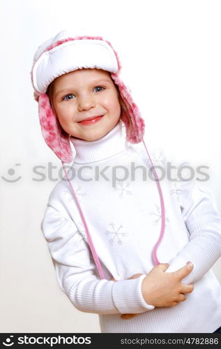 Portrait of little kid in winter wear against white background