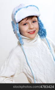 Portrait of little kid in winter wear against white background