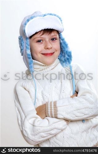 Portrait of little kid in winter wear against white background