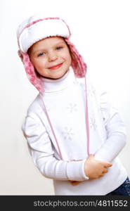 Portrait of little kid in winter wear against white background